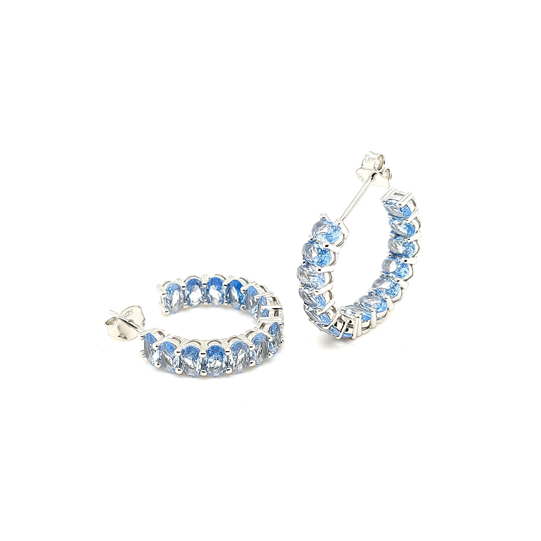 Sterling Jewellers' Ovale Acqua Small Hoop Earrings in Rhodium Plating with Aqua Blue Stones from the new Ovale Collection